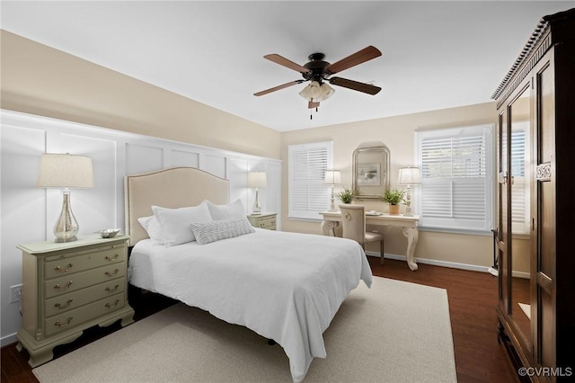 bedroom with ceiling fan and dark hardwood / wood-style floors