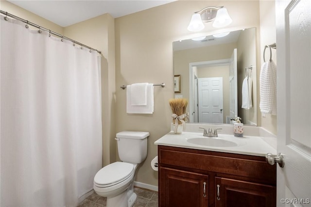 bathroom with tile patterned floors, vanity, and toilet