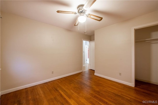 unfurnished bedroom with ceiling fan, dark wood-type flooring, and a closet