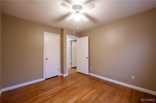 unfurnished bedroom with light wood-type flooring and ceiling fan