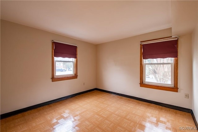 unfurnished room with light parquet flooring