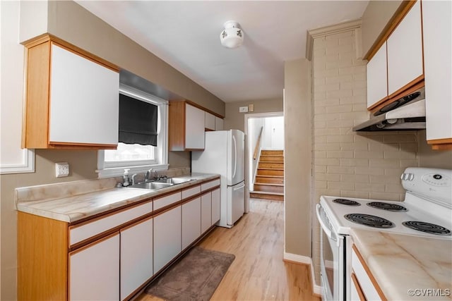 kitchen with tasteful backsplash, white cabinetry, sink, and white appliances