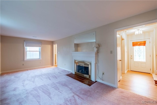 unfurnished living room with light colored carpet