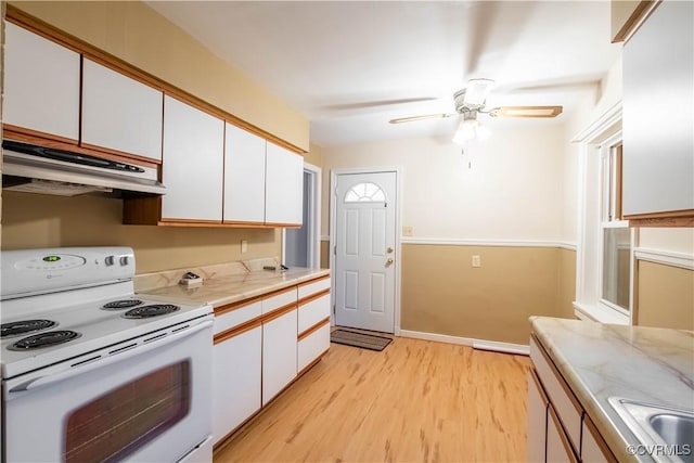 kitchen featuring ceiling fan, sink, light hardwood / wood-style flooring, white electric stove, and white cabinetry