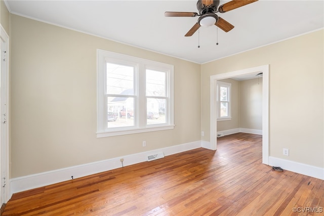 unfurnished room with hardwood / wood-style floors, ceiling fan, ornamental molding, and a wealth of natural light