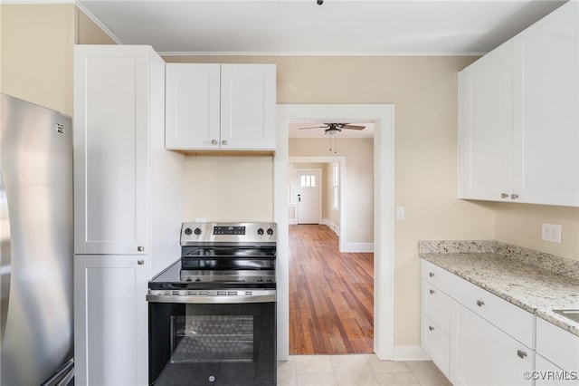 kitchen with white cabinetry, light stone countertops, stainless steel appliances, and light hardwood / wood-style flooring