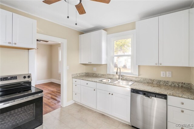 kitchen featuring sink, white cabinets, stainless steel appliances, and light hardwood / wood-style floors