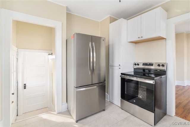 kitchen with white cabinets, light wood-type flooring, stainless steel appliances, and ornamental molding