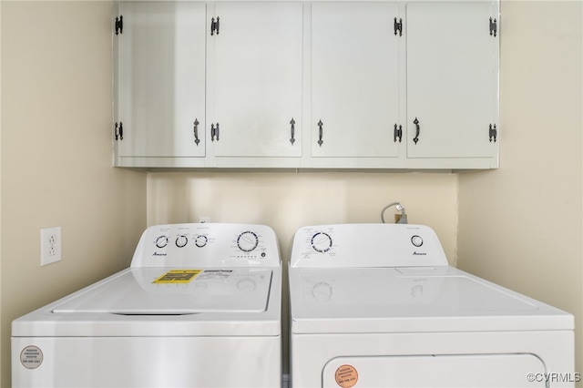 laundry room featuring cabinets and washing machine and dryer