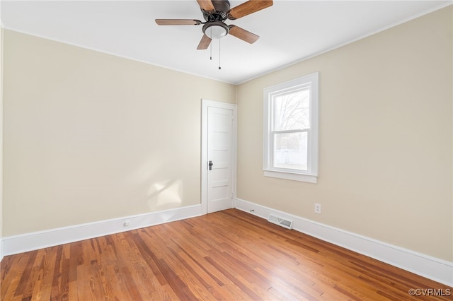 unfurnished room with ceiling fan, wood-type flooring, and ornamental molding