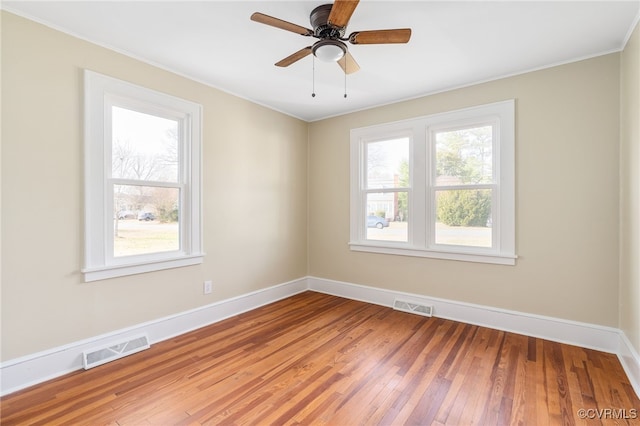 unfurnished room with ceiling fan, ornamental molding, and hardwood / wood-style flooring