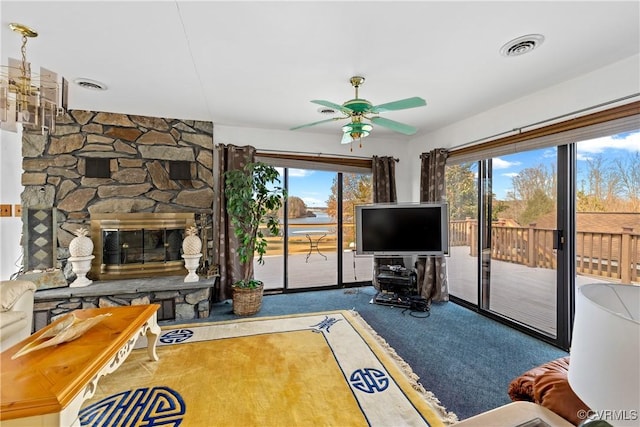 unfurnished living room with carpet flooring, a fireplace, and ceiling fan