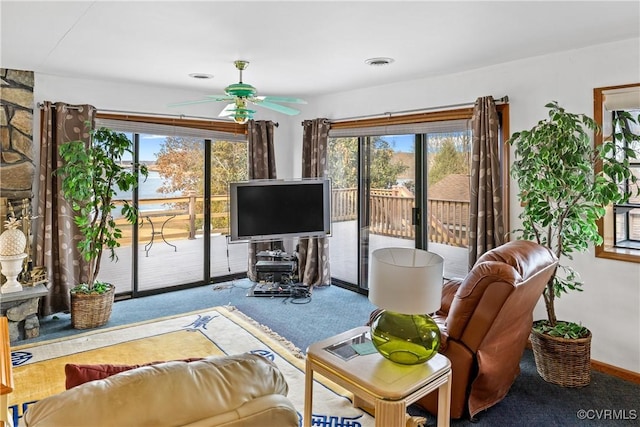 living room with carpet, a wealth of natural light, and ceiling fan