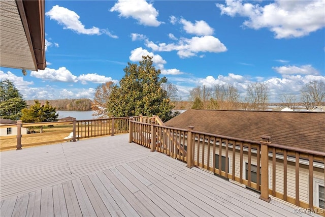 wooden terrace featuring a water view