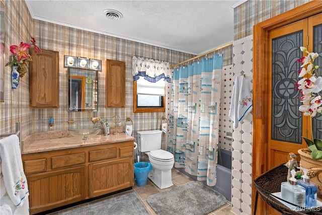 full bathroom featuring tile patterned floors, a textured ceiling, toilet, shower / bath combo with shower curtain, and vanity