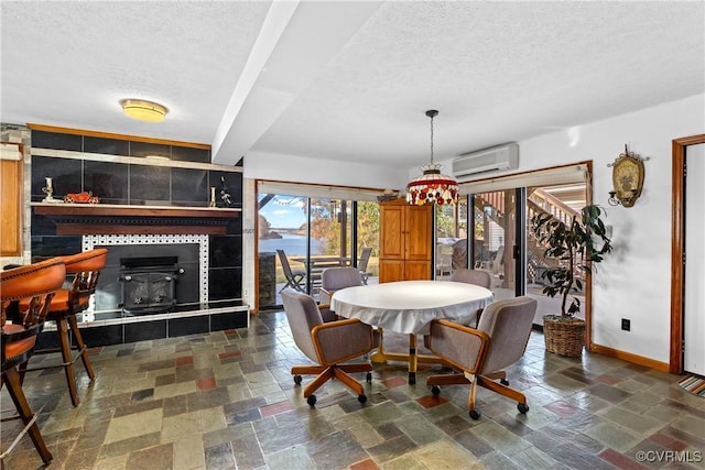 dining room with a textured ceiling and an AC wall unit