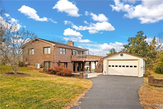 view of front of home with an outdoor structure, a garage, a wooden deck, and a front yard