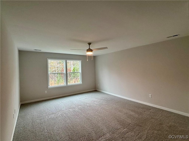 carpeted spare room featuring ceiling fan