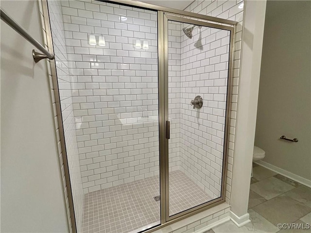 bathroom with tile patterned floors, a shower with door, and toilet