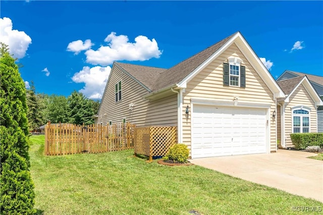 view of front of property with a front yard and a garage