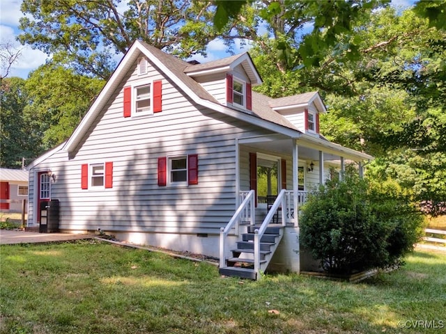 view of front of property with covered porch and a front yard