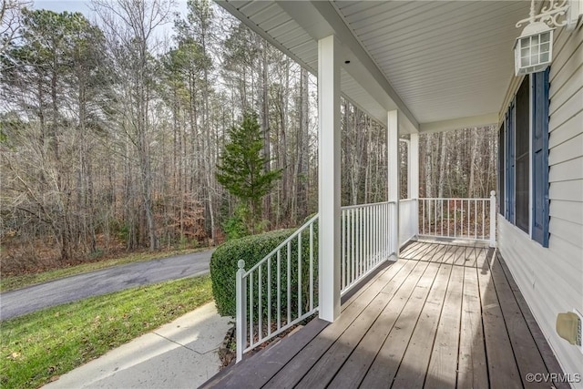 wooden terrace featuring covered porch