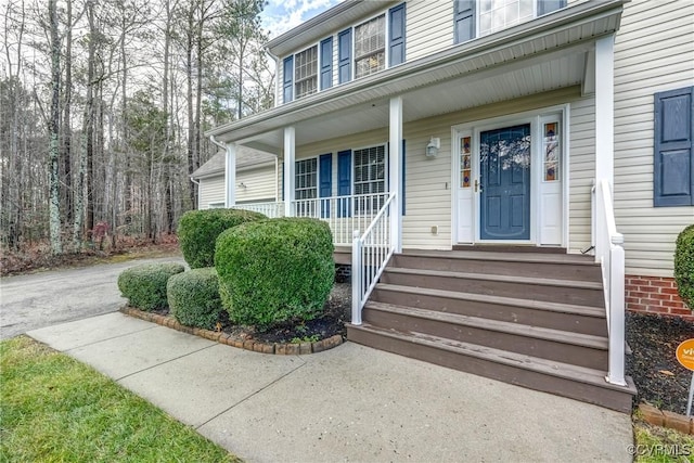 view of exterior entry with covered porch