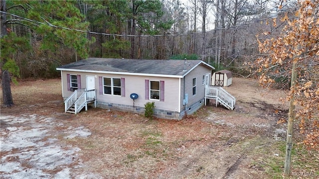 view of front of property featuring a shed