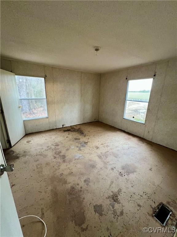 unfurnished room featuring a textured ceiling