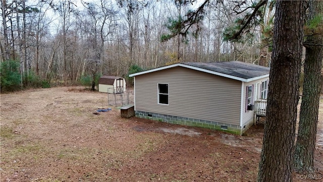 view of side of home featuring a shed