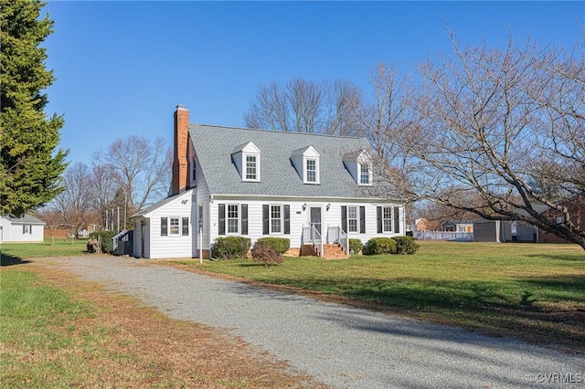 cape cod house with a front yard