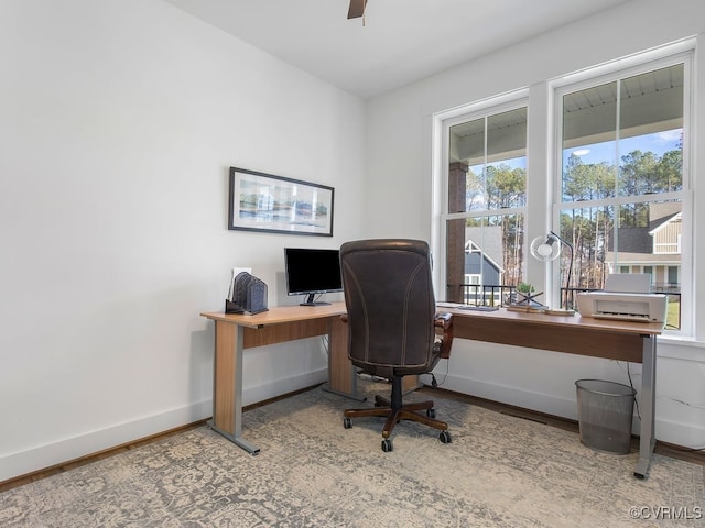 office space featuring a ceiling fan, baseboards, and wood finished floors