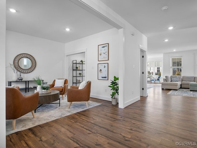 living room with baseboards, dark wood-type flooring, and recessed lighting