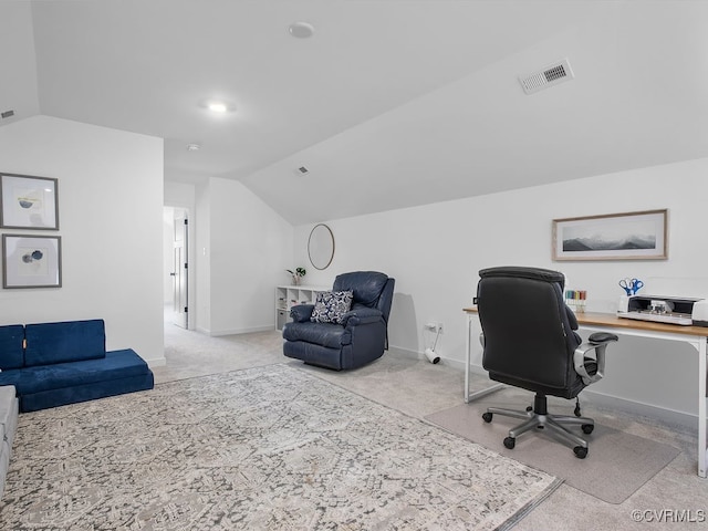 carpeted home office featuring vaulted ceiling, visible vents, and baseboards