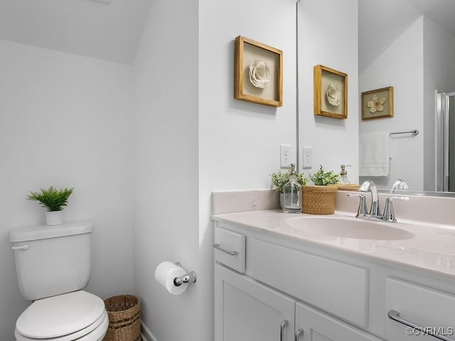 bathroom with vaulted ceiling, vanity, and toilet