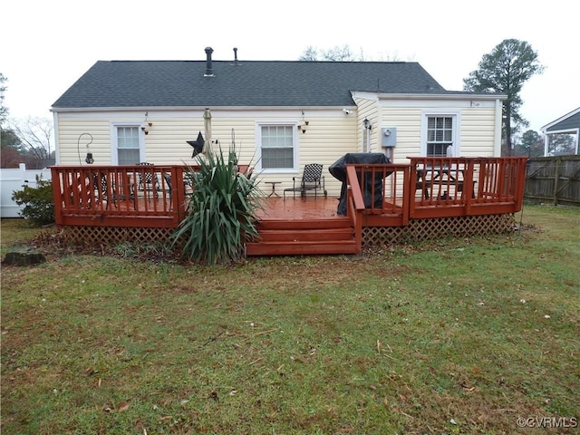 rear view of house with a yard and a deck