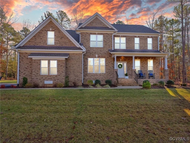 craftsman house with covered porch and a yard