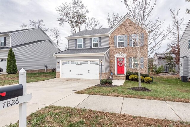 view of front of property with a front yard, central AC, and a garage