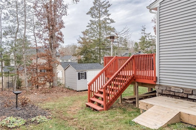 view of yard featuring an outbuilding, a shed, and a wooden deck