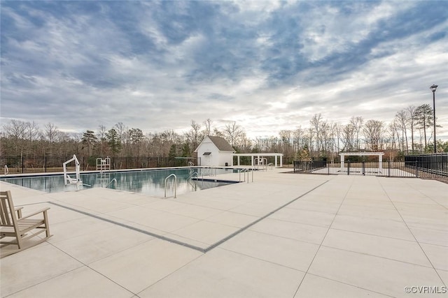 pool featuring a patio area and fence