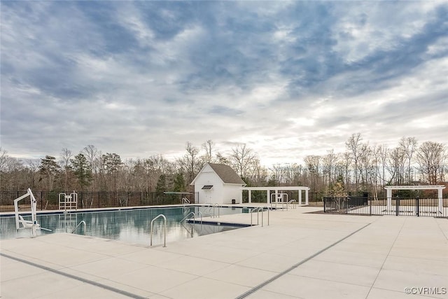 pool with fence, a pergola, and a patio