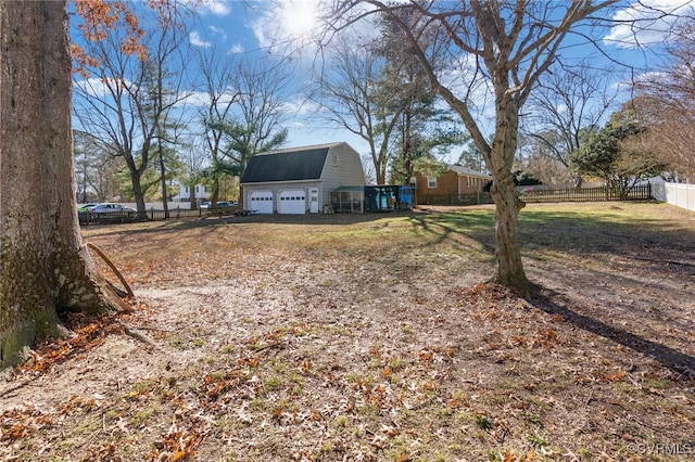 view of yard featuring a garage and an outdoor structure