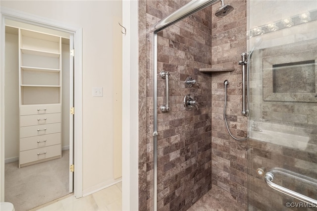 bathroom with tile patterned flooring and a shower with door