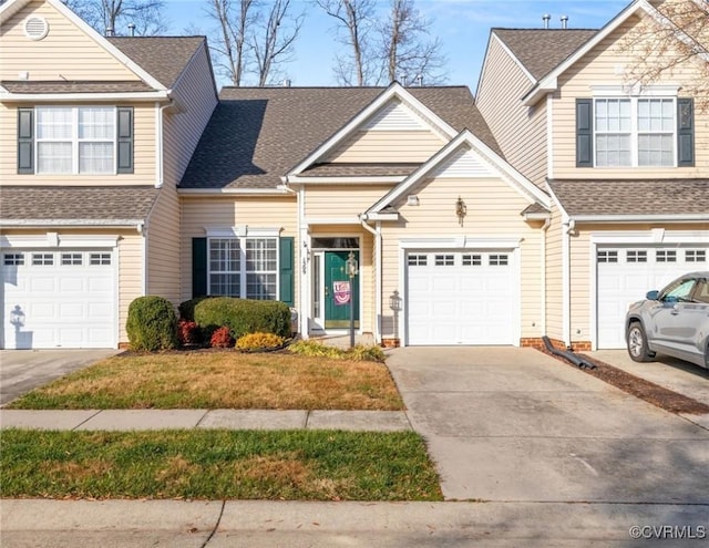 view of front of house with a garage and a front lawn