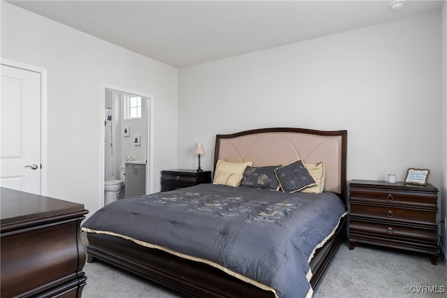 carpeted bedroom with ensuite bath