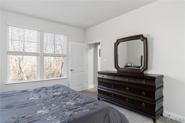 carpeted bedroom with multiple windows