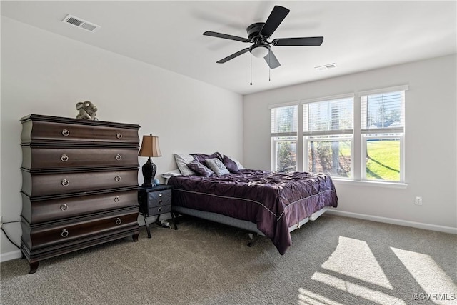 bedroom featuring multiple windows, ceiling fan, and light colored carpet