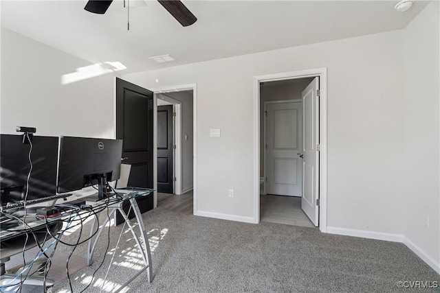 unfurnished office featuring carpet flooring and ceiling fan