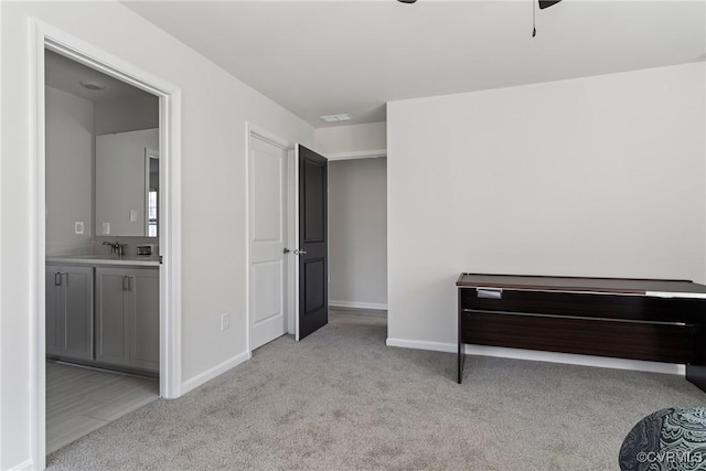 miscellaneous room with light colored carpet