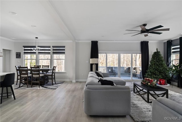 living room featuring light hardwood / wood-style flooring, ceiling fan, and ornamental molding